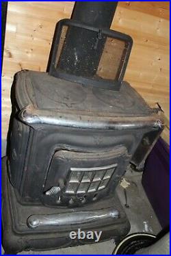 Vintage cast iron wood burning parlor stove, fireplace with cook top good shape